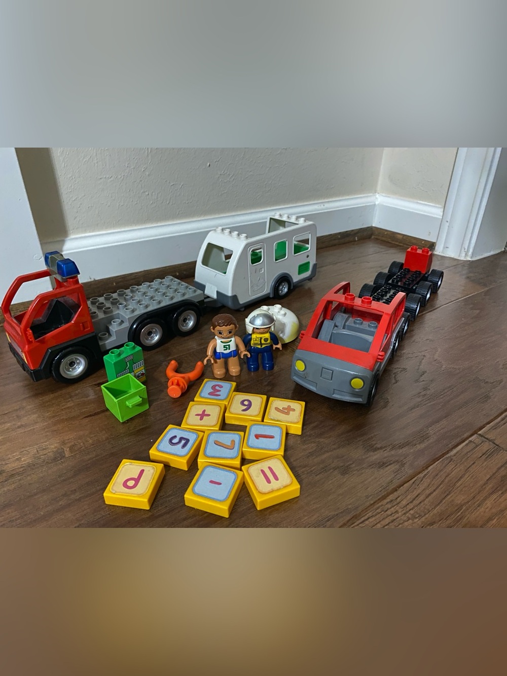 assorted LEGO DUPLO vehicles, figures, and interactive learning blocks